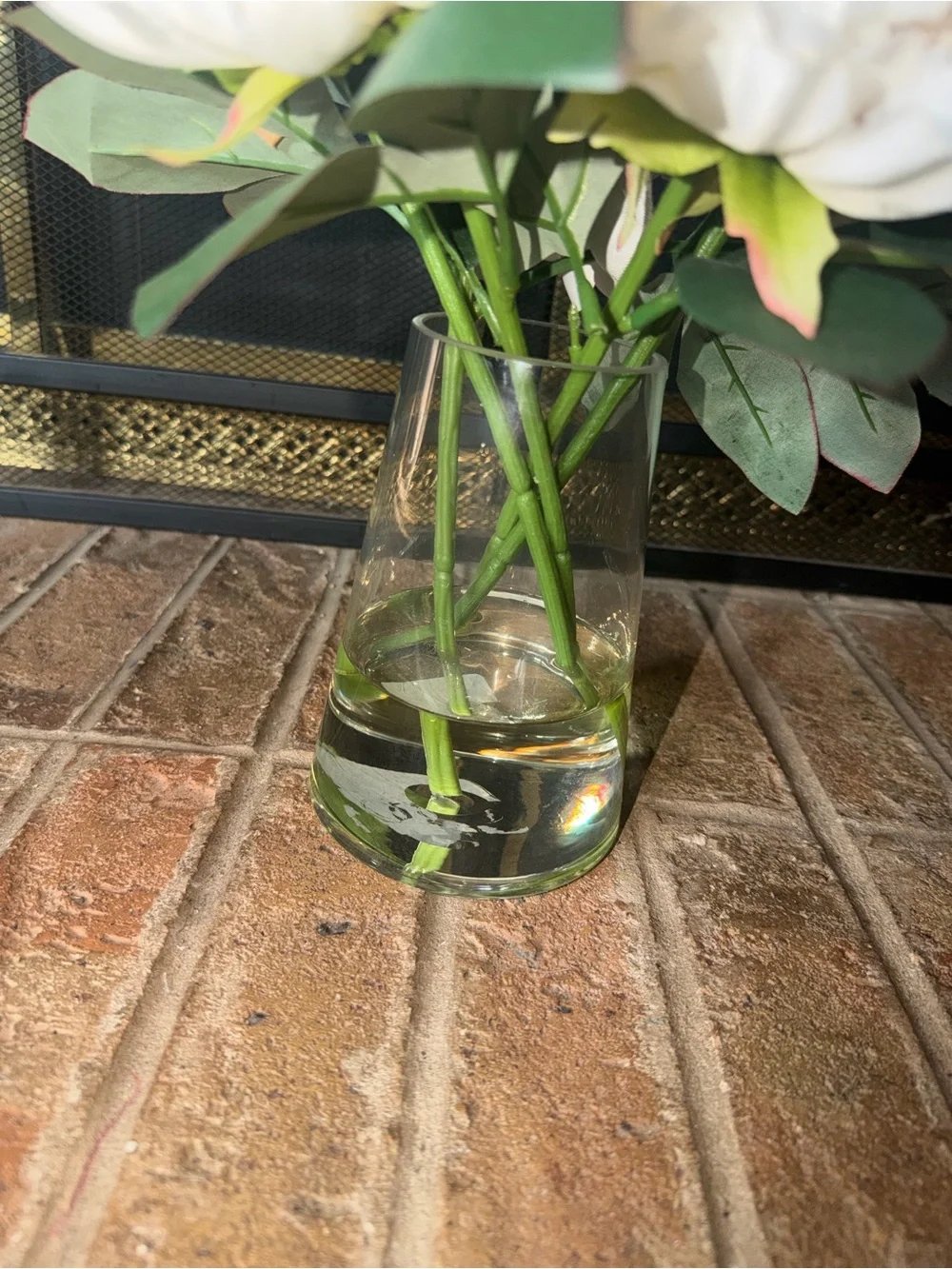 11” cute white bouquet flowers anchored in glass vase